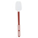 A close-up of a red Vollrath SoftSpoon Silicone Spoonula with a black handle.