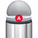 A close up of a simplehuman white trash can liner with a red circle and white letter A.
