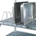 A Metro Metromax iQ drying rack with metal trays on it.