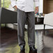 A man wearing Uncommon Chef gray and black chevron stripe chef pants.