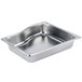A Vollrath stainless steel pan with a curved edge.