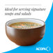 A brown matte stoneware bowl filled with soup.