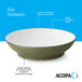 A stoneware pasta bowl with a glossy white interior, dark banded edge, and a warm green matte speckled exterior.