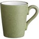 A moss green stoneware mug with a handle.