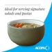 A moss green matte stoneware bowl filled with soup.