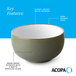 A stoneware bowl with a warm green matte speckled exterior, a glossy white interior, and a dark banded edge.
