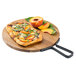 An acacia wood serving board with a flatbread topped with peaches, basil, and cheese.