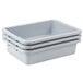 A stack of three Rubbermaid gray plastic bus tubs.