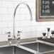 A Waterloo deck-mount faucet with 12" gooseneck spout and 4" centers over a sink with a chalkboard above it.