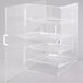 A clear plastic Cal-Mil pastry display case with four shelves.