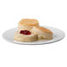 A close up of a Krusteaz buttermilk biscuit with jam on a plate.