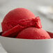 A close-up of a bowl of red cherry Italian ice.