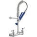 A silver Waterloo wall-mounted pre-rinse faucet with blue handles.