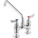 A silver Waterloo deck-mounted faucet with two red knobs and a 10" swing spout.