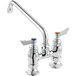 a silver faucet with red knobs