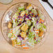 A salad with lettuce and croutons on an Arcoroc Roc salad plate.