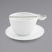 A white cup with a saucer underneath.