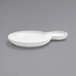 A close-up of a white Front of the House Harmony 2-compartment porcelain plate with a spoon on it.