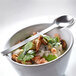 A bowl of food with a Front of the House stainless steel demitasse spoon.
