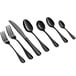 A close-up of several Acopa Vernon black stainless steel demitasse spoons.