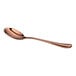 A shiny, rose gold-colored spoon with a smooth, curved handle and oval bowl, shown on a white background.