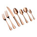 A set of seven rose gold-colored utensils, including two forks, one knife, and four spoons, arranged in a row on a white background.