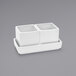 A white rectangular porcelain ramekin with two square containers inside.