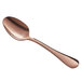 A close-up of an Acopa Vernon rose gold stainless steel teaspoon with a rose gold handle.