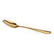 A gold-colored, oval-bowl spoon with a sleek, curved handle shown against a white background.