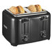 A Proctor Silex toaster with three buns in the slots.