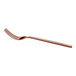 A rose gold-colored metal fork with four tines and a slightly curved handle, shown on a white background.
