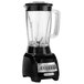 A close-up of a Hamilton Beach black blender base with a clear glass container.
