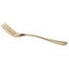 A close up of an Acopa Vernon gold salad/dessert fork with a curved tool end.
