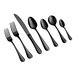 Seven pieces of black cutlery, including two forks, one knife, and four spoons, are arranged in a row on a white background.