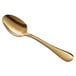 An Acopa Vernon gold stainless steel teaspoon with a long handle.