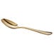 A close-up of the gold handle of an Acopa Vernon stainless steel teaspoon.