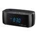 A black Conair digital alarm clock with blue numbers showing the time.