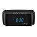 A black digital alarm clock with blue numbers.