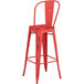 A Lancaster Table & Seating red metal outdoor cafe barstool with a backrest.