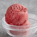 A bowl of Acai Roots organic red sorbet with a scoop on top.