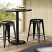 Lancaster Table & Seating Alloy Series Distressed Black Stackable Metal Indoor / Outdoor Industrial Cafe Counter Height Stool with Drain Hole Seat Main Thumbnail 1