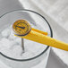 A yellow AvaTemp pocket thermometer in a glass of ice.