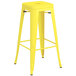 A yellow metal Lancaster Table & Seating backless barstool.