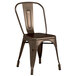 A brown metal Lancaster Table & Seating outdoor cafe chair.