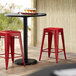 Lancaster Table & Seating Alloy Series Red Stackable Metal Indoor / Outdoor Industrial Cafe Counter Height Stool with Drain Hole Seat Main Thumbnail 1