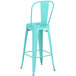 A seafoam metal Lancaster Table & Seating bar stool with a backrest.