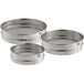 A silver sieve set with three round metal containers.