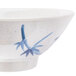 A close-up of a blue and white Thunder Group Blue Bamboo melamine rice bowl with a round design.