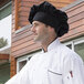 A man wearing a black Uncommon Chef twill chef hat.