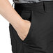 A person wearing Uncommon Chef black straight leg chef pants with their hand in their pocket.